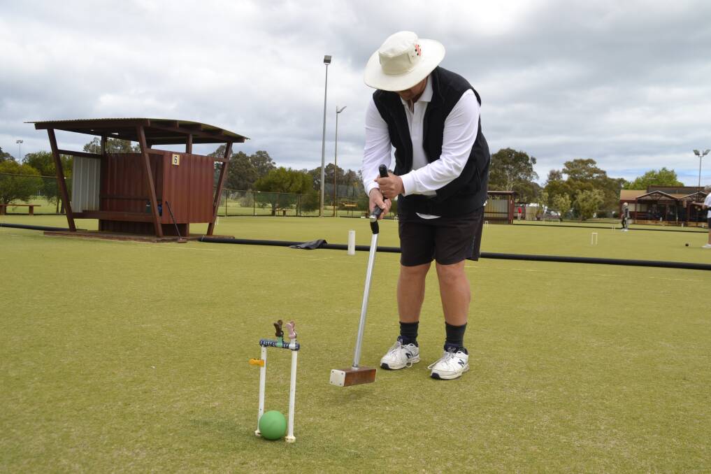 Mr Phipps playing association croquet at the club's courts in Hay Park. 