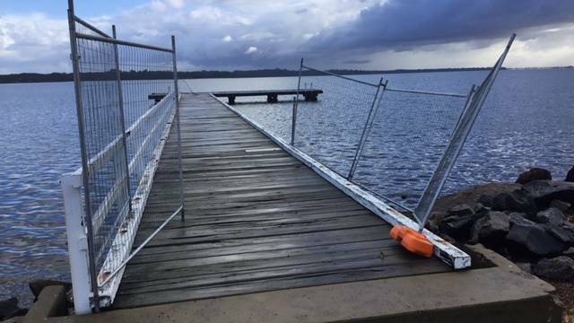 Damage to the jetty includes holes made from washed away gravel, missing or damaged railing and broken planks. Picture: Supplied
