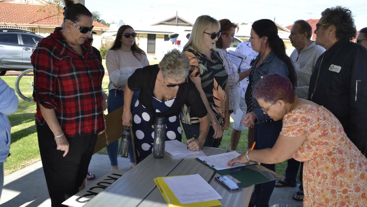 Glen Iris and Vittoria Heights residents signing one of the petitions at the 'Say No to BFM' protest on May 1. 