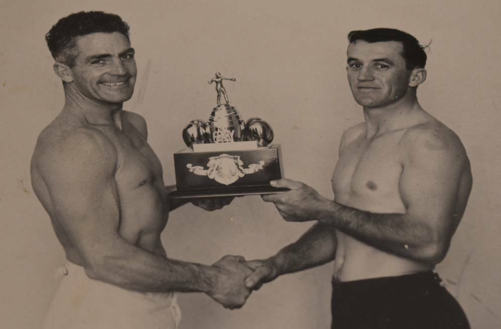 Over the years: Bill Ivory when he was the WA state coach, presenting a trophy to 1965 golden gloves champion Ray Arthur. Picture: Supplied 