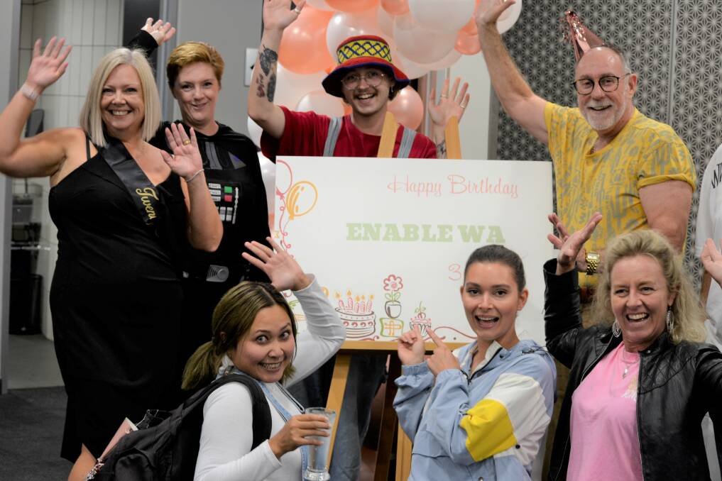 CEO Rob Holmes pictured with the Bunbury staff from Enable who were all dressed in 90's fashion to celebrate their big birthday. 