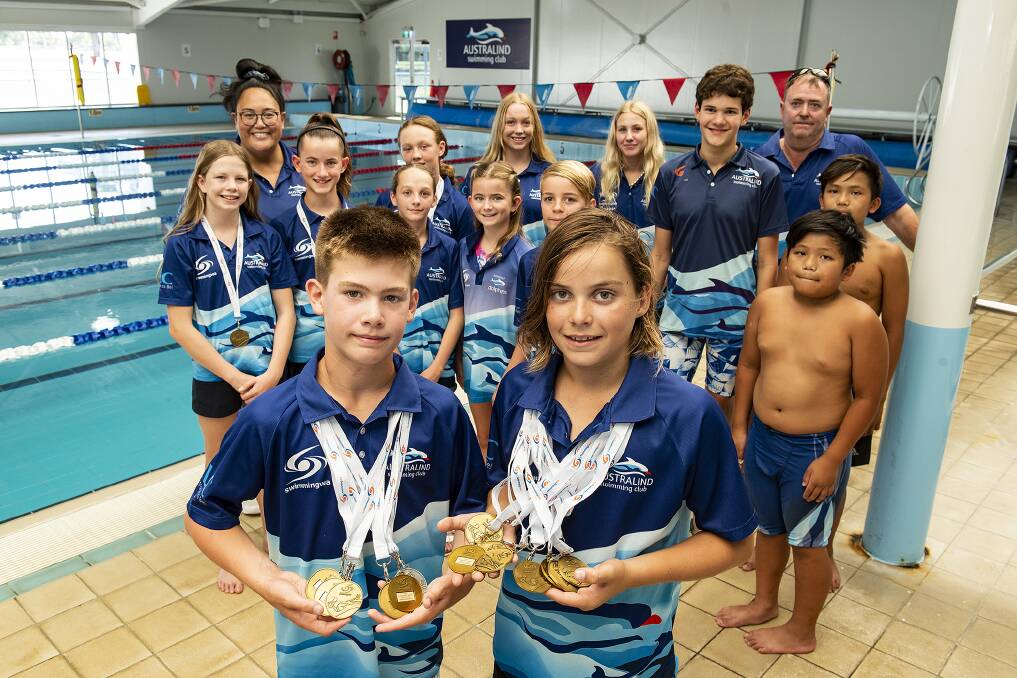 Club winners: Kael OByrne and Jay Pfoeffer with swimmers and coaches from Australind Swimming Club. Picture: David Bailey