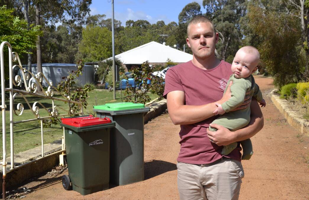 Simon with baby Rylan: Mr Bushell said the 140 litre general waste bin was not enough for his soon-to-be family of four. 