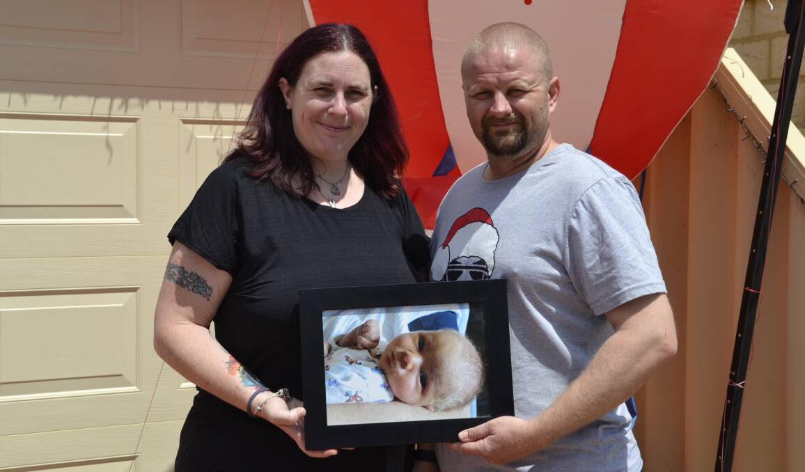 In memoriam: Proud parents Karen and Steven with a photo of their baby boy, Xander. Picture: Pip Waller