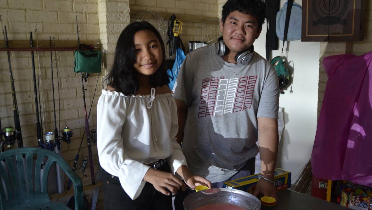 Olivia's daughter Denise and her son, Gabriel, helping make some of the puto (steamed rice cake).