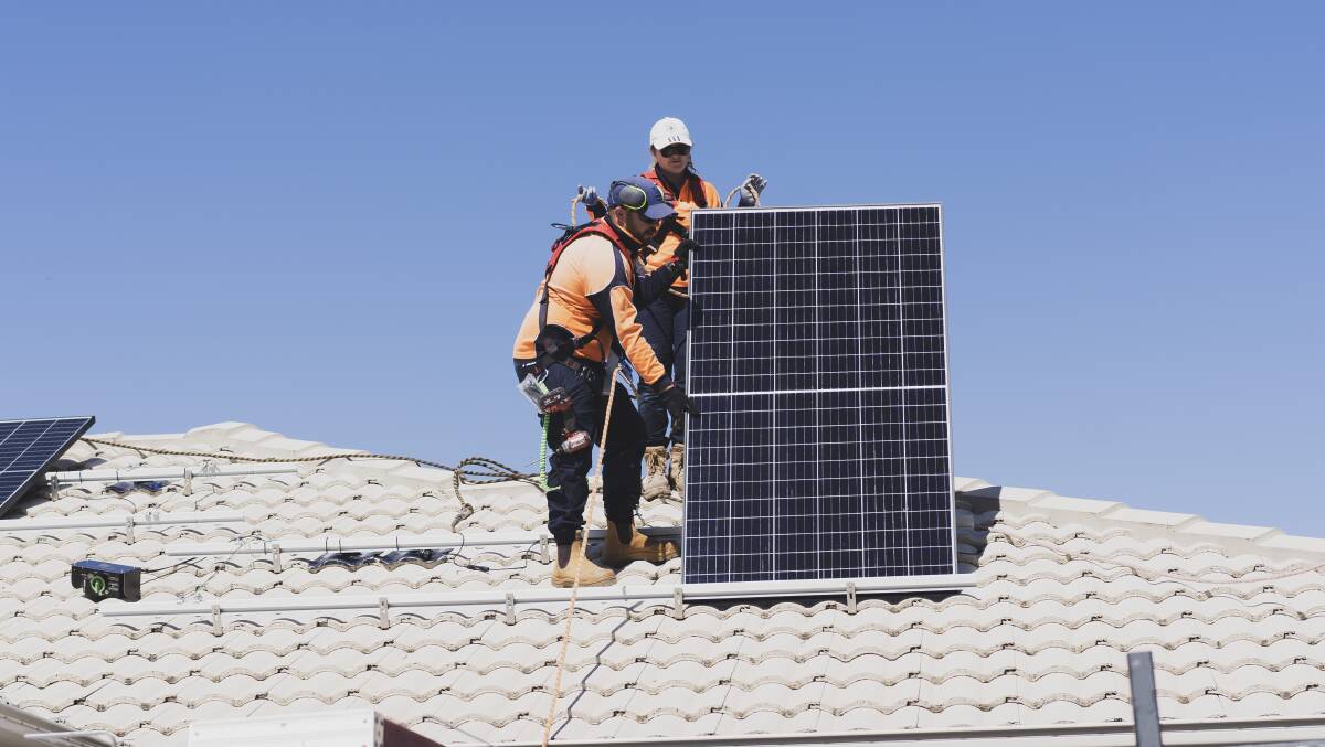 Canberra SolarHub employees installing solar panels on a house in Bonner in the ACT. Picture by Dion Georgopoulos