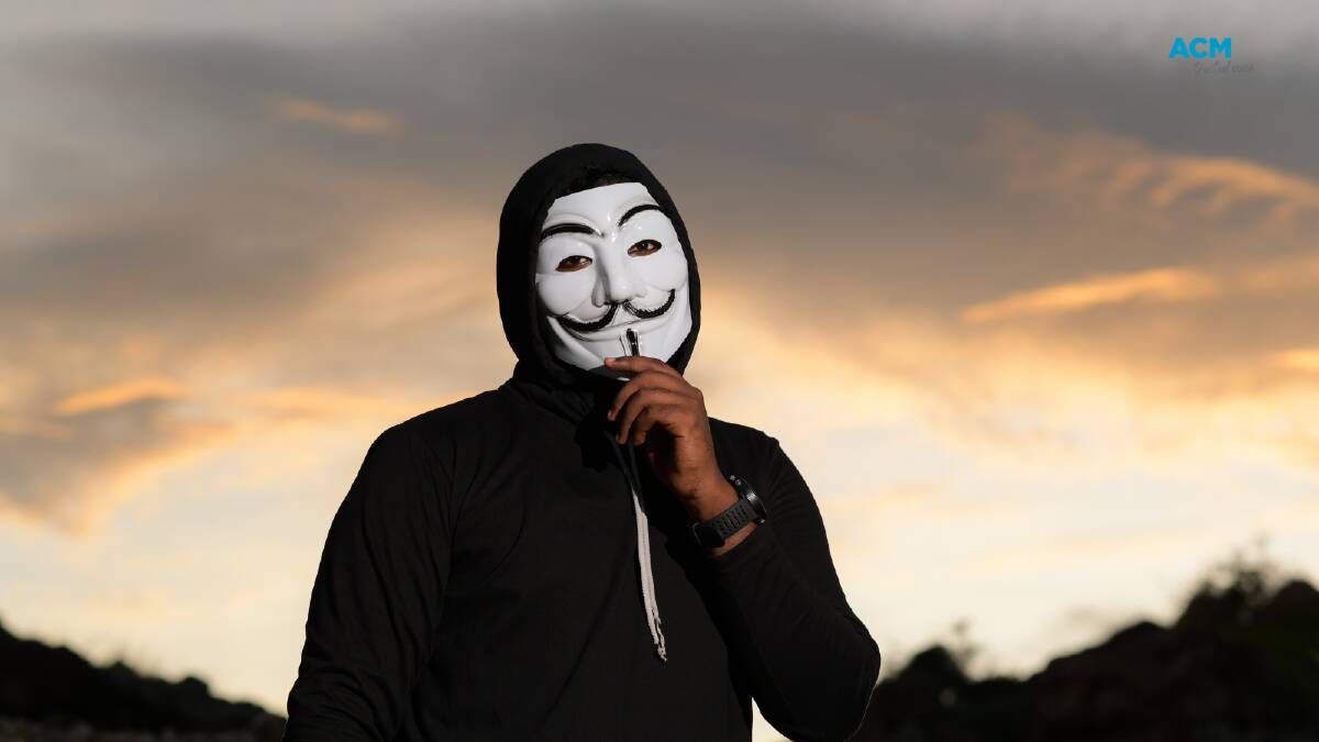 Man wearing a Guy Fawkes mask popular with 'anonymous' hackers. Picture via Canva