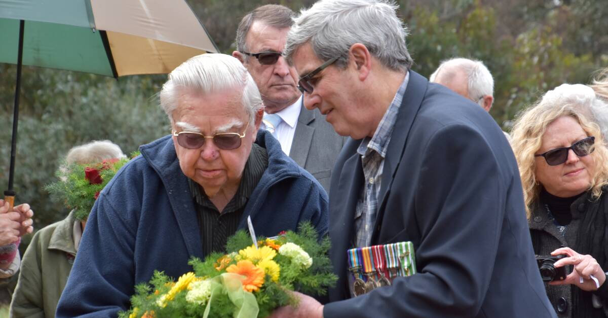 Lest we forget: Max Barrington assists Vern Daulby to place a wreath at the Somme Creek memorial, exactly 100 years after the bloody battle. Photo: Lee Steinbacher