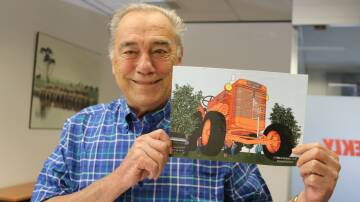 Carnamahs former machinery dealership owner, Hal Walton, holding a picture of the Chamberlain 40K tractor the first Chamberlain tractor to be manufactured in WA.