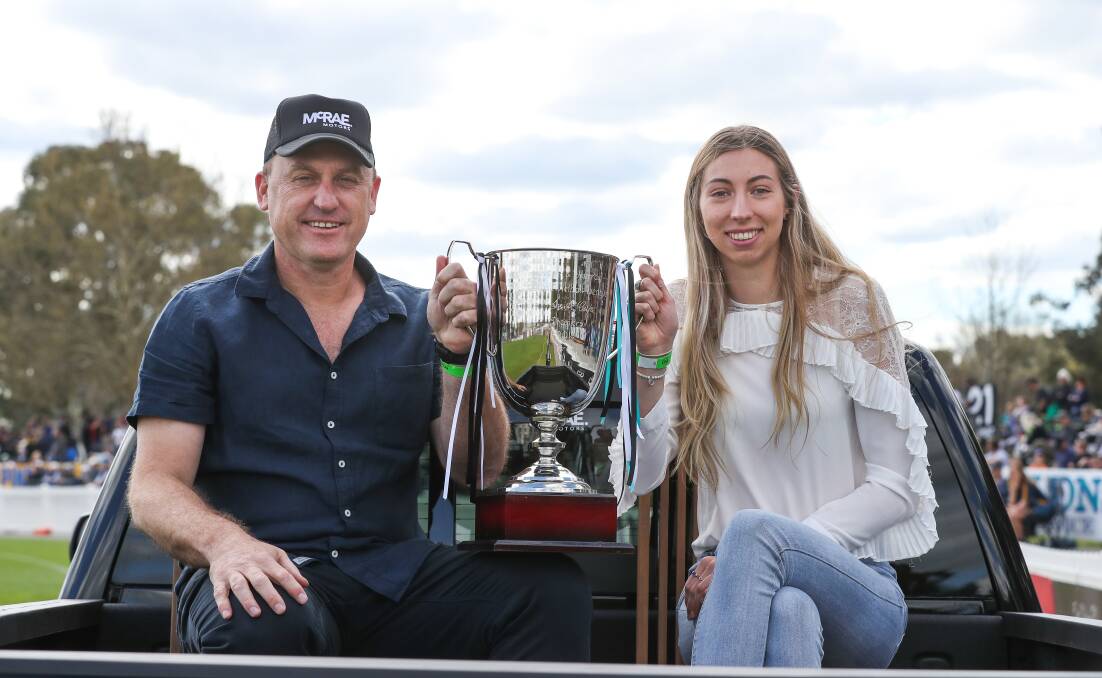 STAR: Jacqui Newton poses alongside John Longmire during the Parade of Champions at the Ovens and Murray League grand final last year.