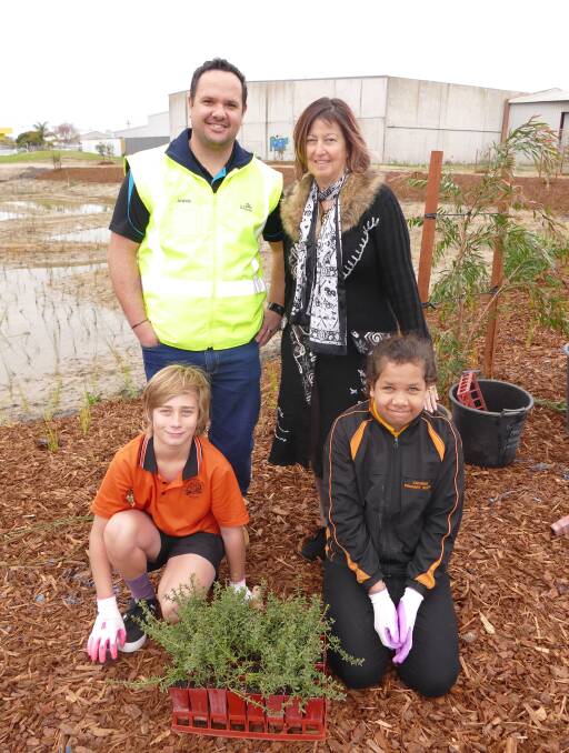 Green thumbs: City of Bunbury engineering technical officer, program and planning André van der Merwe and Cooinda Primary School principal Anne Fletcher with students Max Muellner and Samara Ugle. Photo: Supplied. 
