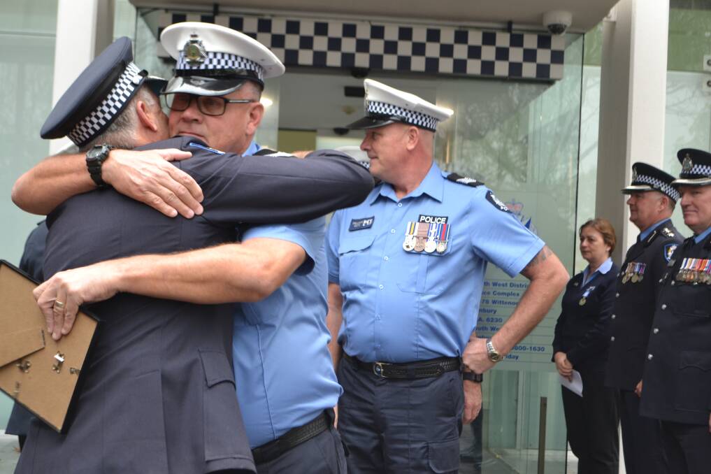 Saying goodbye: Outgoing Harvey Police Officer in Charge Laurie Morley embracing South West District Superintendent Mick Sutherland on Friday. Photo: Thomas Munday. 