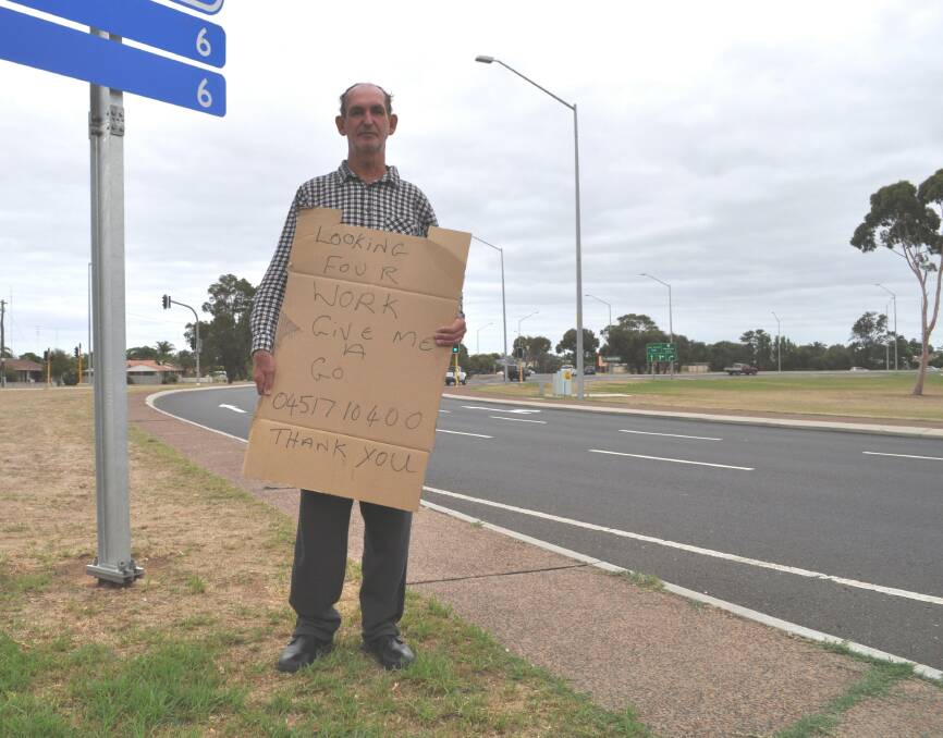 Looking for work: Arthur Bennett, 59, has been seen out on the Eelup Rotary Roundabout, near Sandridge Road, with his sign. Photo: Thomas Munday. 