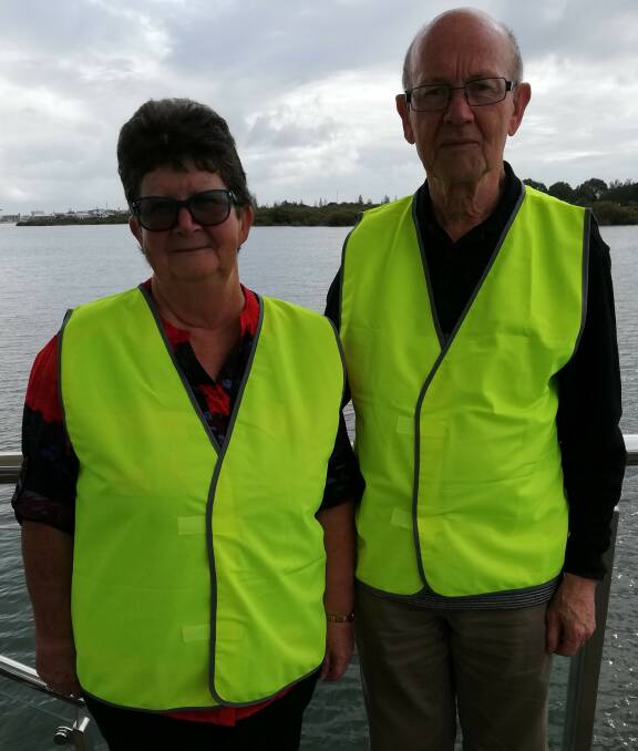 Listening in: Lip-reading instructor Cynthia Dutton and treasurer Roger Thornton wearing the high-vis vests. Photo: Supplied. 