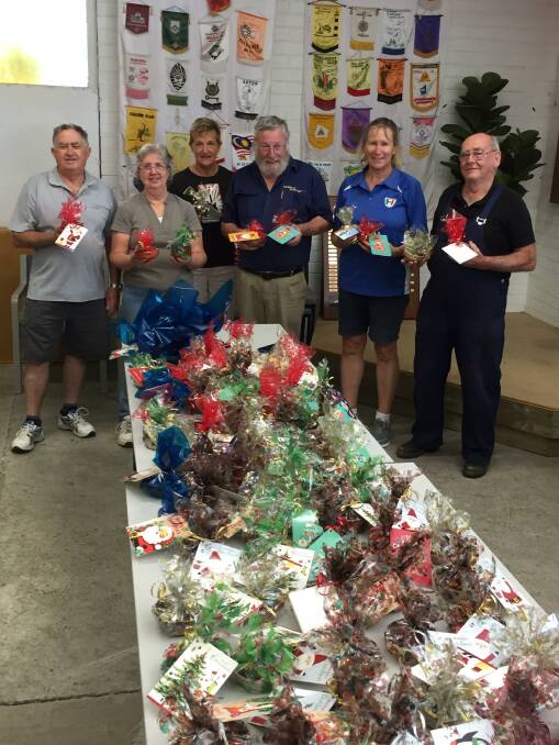 Working together: The Bunbury Woodturners Group created 100 wooden bowls to help Silver Chain during the festive season. Photo: Supplied. 