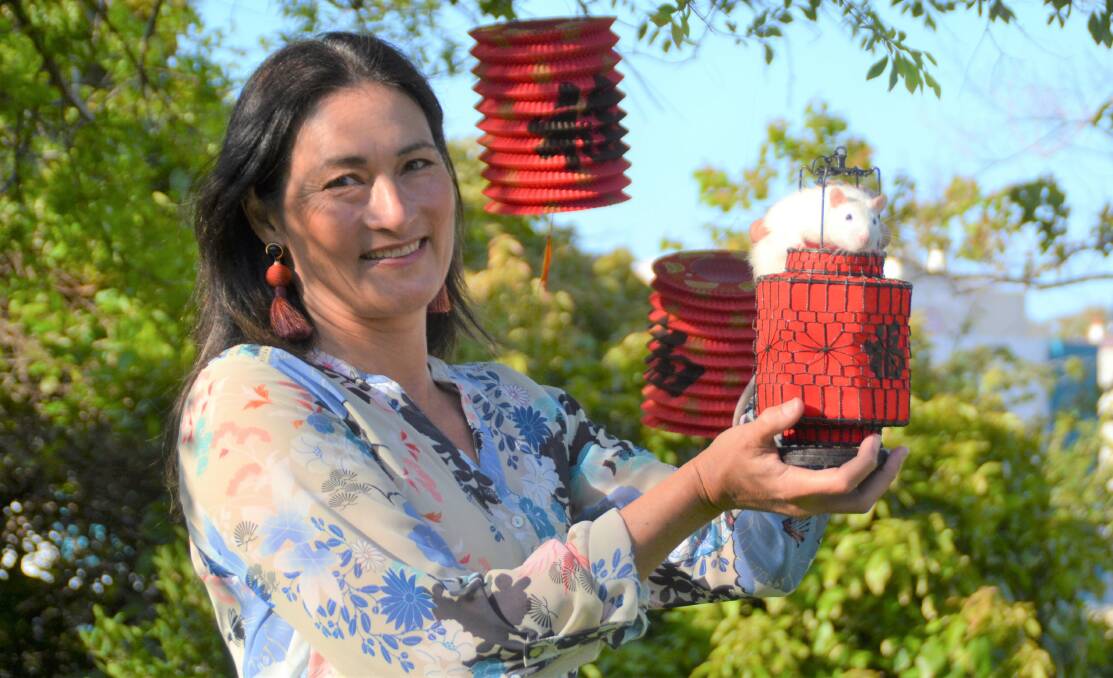 Sea of red: Bunbury Chinese New Year Festival organiser Amanda Yip with Spot the rat. Next year's event will be held on Saturday, March 7. Photo: Thomas Munday. 