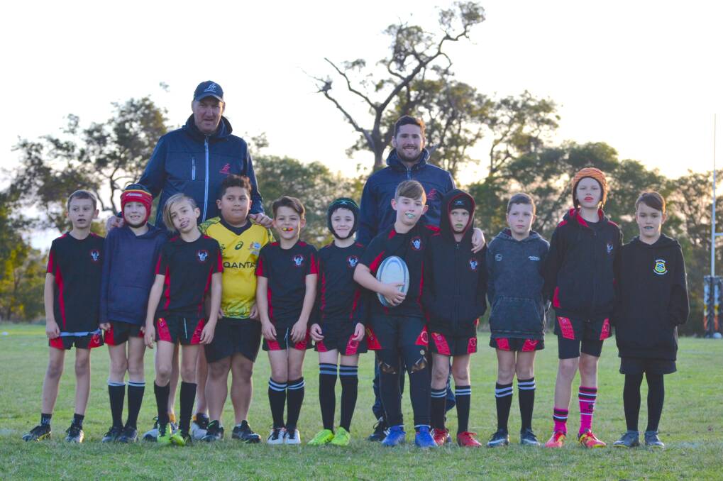 Leading the charge: Wallabies legends Justin Harrison and Nathan Charles with some of the Bunbury Junior Barbarians players. Photo: Thomas Munday. 