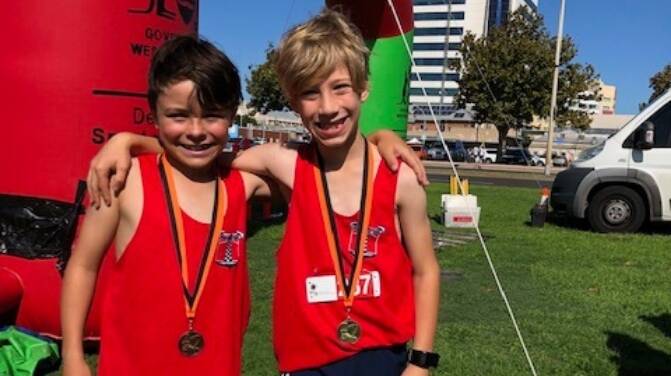 Racing hearts: Bunbury Primary School students Cohen Tappenden and Oliver Kuhn, both 8, finished first and third in the U8s, 2km run. Photo: Supplied. 