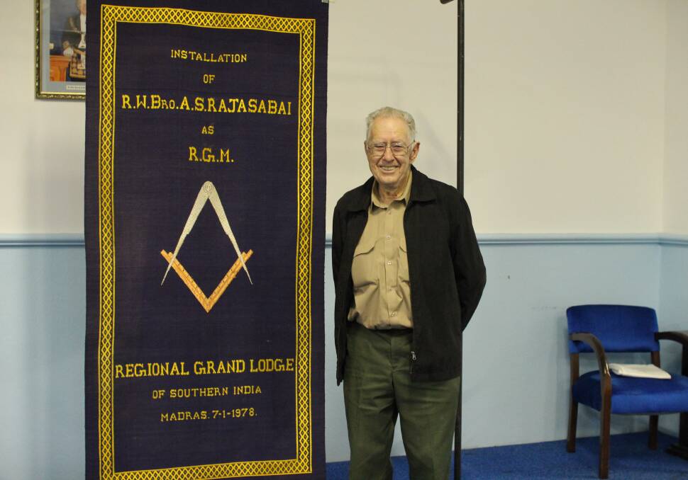 Mr Reimers stands alongside the 40-year-old silk mat belonging to the Regional Grand Lodge of Southern India. Photo: Jesinta Burton.