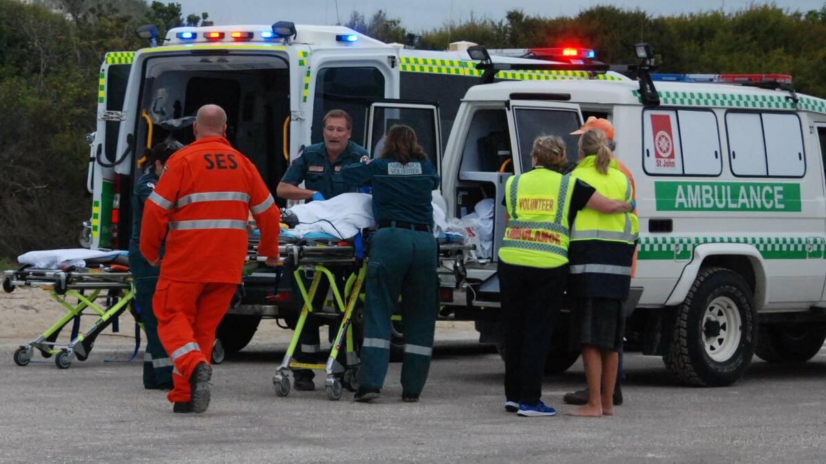 Harrowing final moments: Esperance community paramedic Paul Gaughan with emergency services desperately trying to save Laeticia, as Julie watches on while being comforted by a ambulance office. Photo: Caitlyn Rintoul.