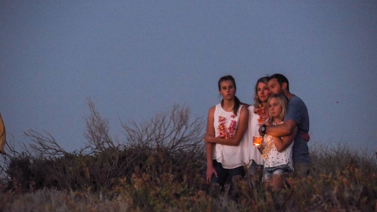 Family: Leon, Julie, Alyssa and Eden Brouwer watch from the dunes as tributes flowed at Singleton Beach at a special event held after Laeticia's death. Photos: Marta Pascual Juanola