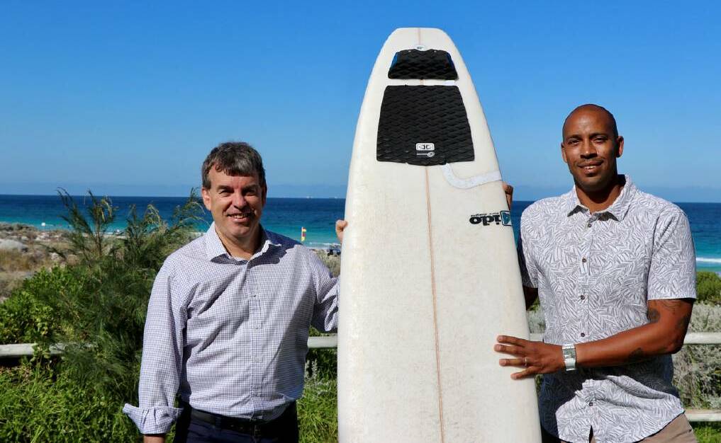 Fisheries minister Dave Kelly with Justin Majeks from Surfing WA and a surfboard with the Ocean Guardian FREEDOM+ SURF device attached.