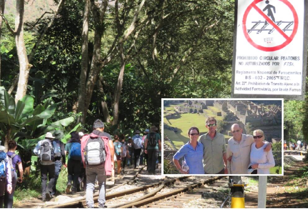WATCH YOUR STEP: Tourists walk along railway tracks through the Peruvian jungle after PeruRail suspended services last week. Photo: supplied.