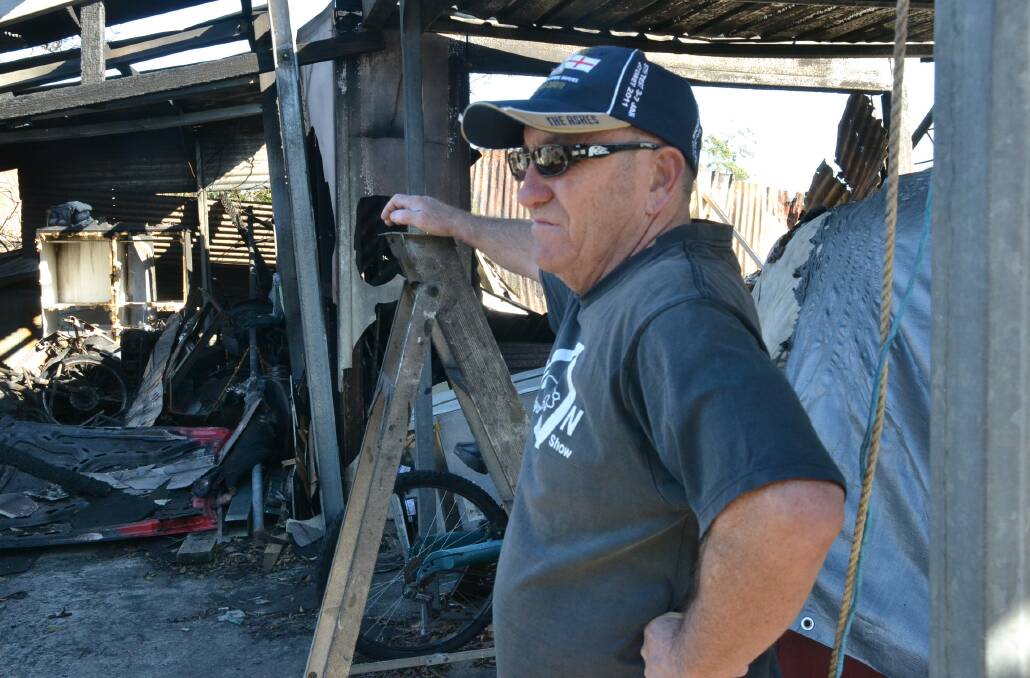ALIVE AND WELL: Ned Ashley back at his Bomaderry home on Thursday morning surveying the damage from Wednesday’s fire.