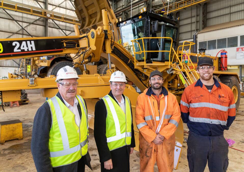 Collie-Preston MLA Mick Murray and Premier Mark McGowan with Premier Coal's Joel Simmonds and Paul Rinder in front of a rebuilt Caterpillar 24H Grader. Photo: supplied