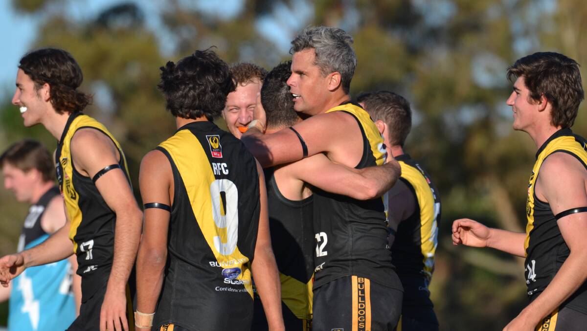 Brett Peake congratulated by teammates after kicking 12 goals in the round 18 clash with Collie. Photo: Thomas Munday.