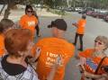 One Nation Party Leader Pauline Hanson signing a volunteer's shirt with the phrase, "Don't burn the chips but deep fry the majors". Picture: Perri Polson. 