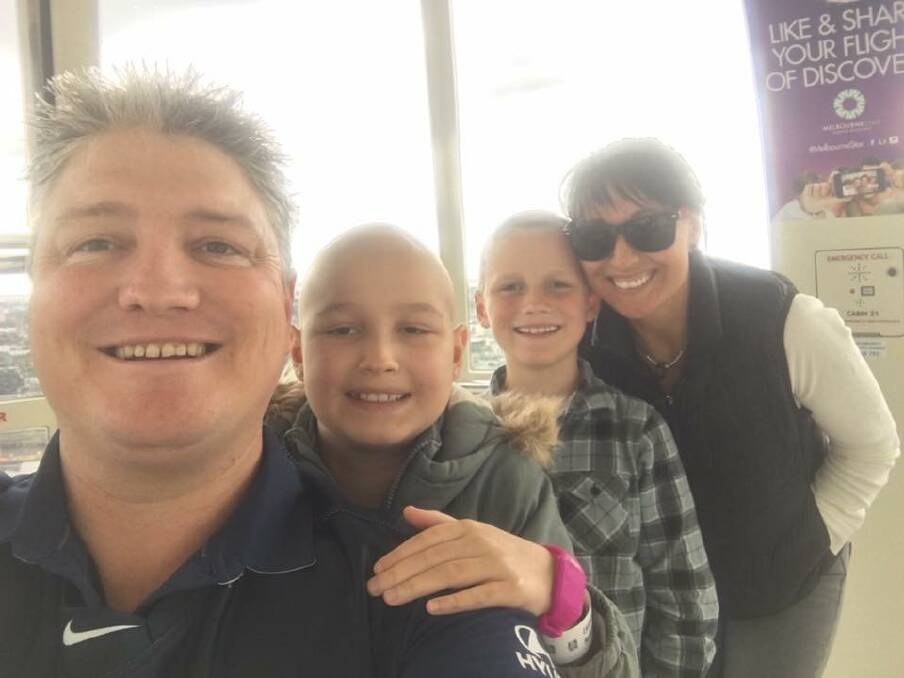 STORY SHARED: Rosie Carroll, 10, pictured (middle) with dad Travis, brother Zack and mum Vanessa is one of six children who are the faces of McHappy Day on Saturday. 