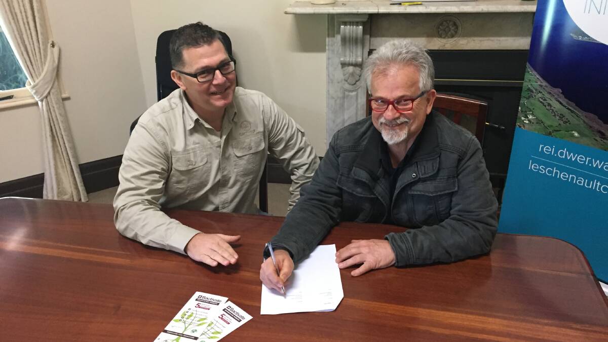 Growise representative John Rukavina signs the Memorandum of Understanding with Leschenault Catchment Council chairman Adrian Azzari-Colley. Image supplied. 