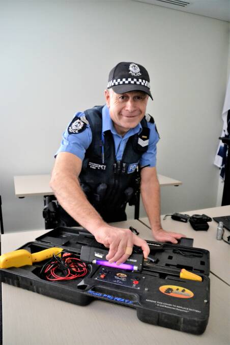 Protect your property: South West Community Engagement Senior Constable Neale Horsley showing how the UV pen works. Photo: Emily Sharp. 
