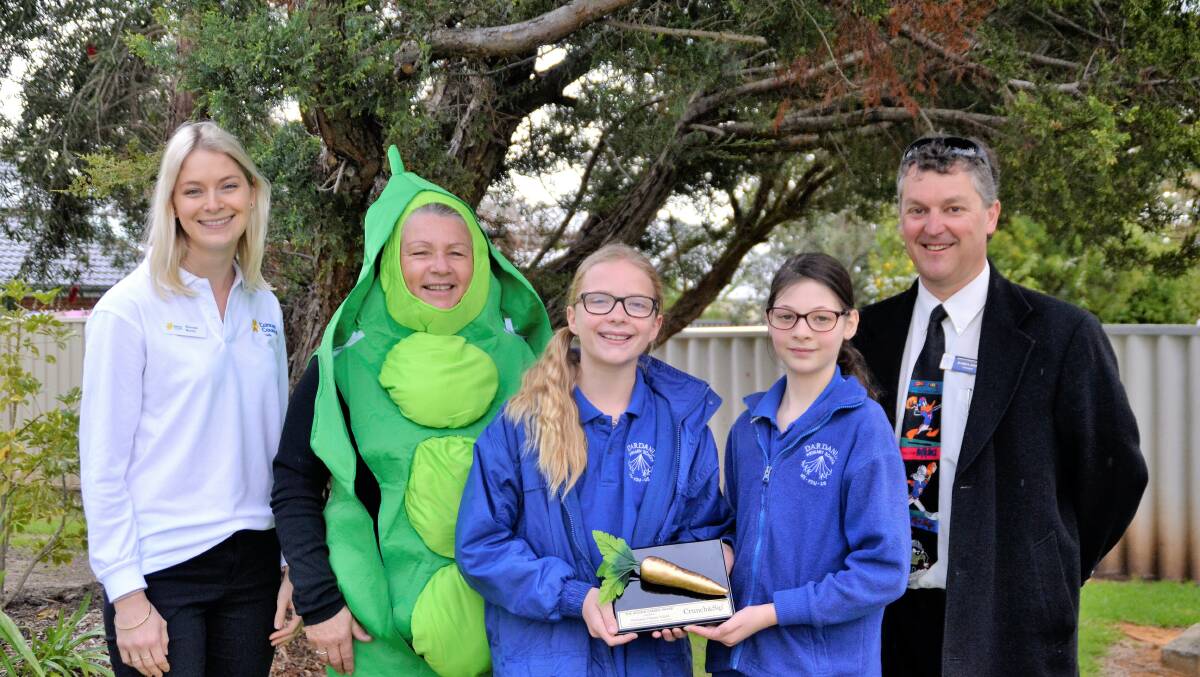 Cancer Council's Shenae Norris, Crunch and Sip coordinator Bev Fortescue, Dardanup Primary School students Ruby Milton and Alaura Newman holding the Golden Carrot award with principal Darryl Owen. 