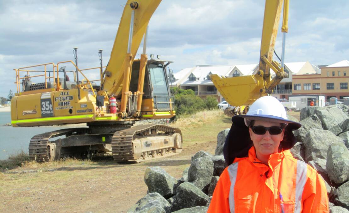 Department of Transport on-site supervisor Olaya Lope-Casado with a long reach excavator to be used in the work.