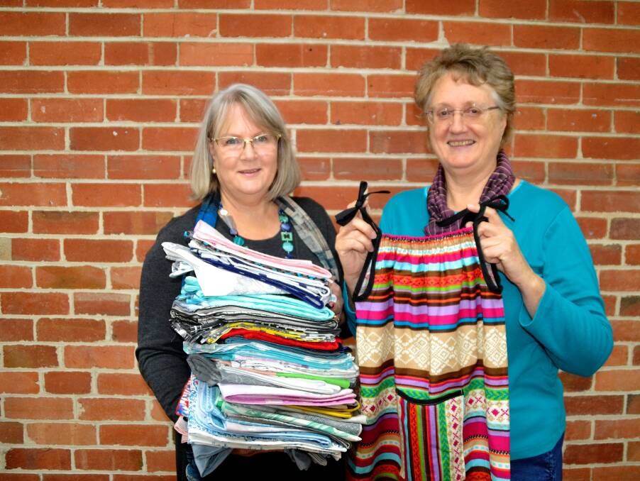 Compassion project: Lorraine Lea Linen consultant Vickie Cain drops off another bunch of pillow cases to Creative Textiles group coordinator Judith Morrisey. Photo: Emily Sharp.