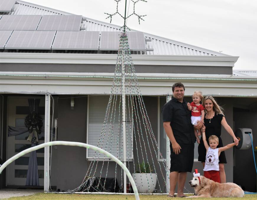 A Christmas delight: The McLaren Family - Dan, Annalise, 1, Nate, 3, Mel and golden retriever Lily out the front of their winning light display. Picture: Emily Sharp.
