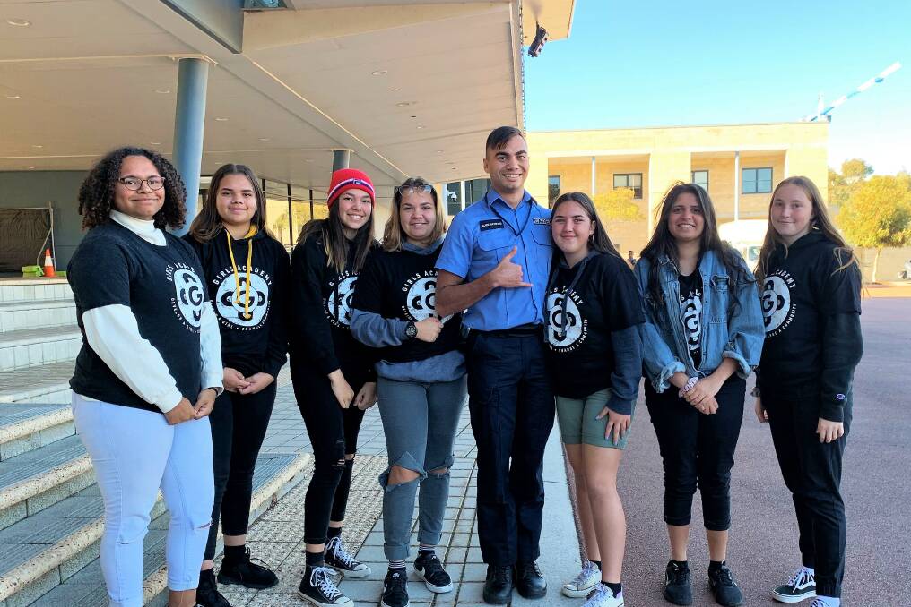 Sky's the limit: Newton Moore Senior High School Girls Academy students Maya Hume, Charity-Rose Ryder, Aaliyah Thomas, Amanda Riley, Tia Holt, Mikayla Farrant and Crystal Kearney with police cadet and former education officer Slade Hayward at the WA Police Academy in Joondalup. Photo: Supplied. 