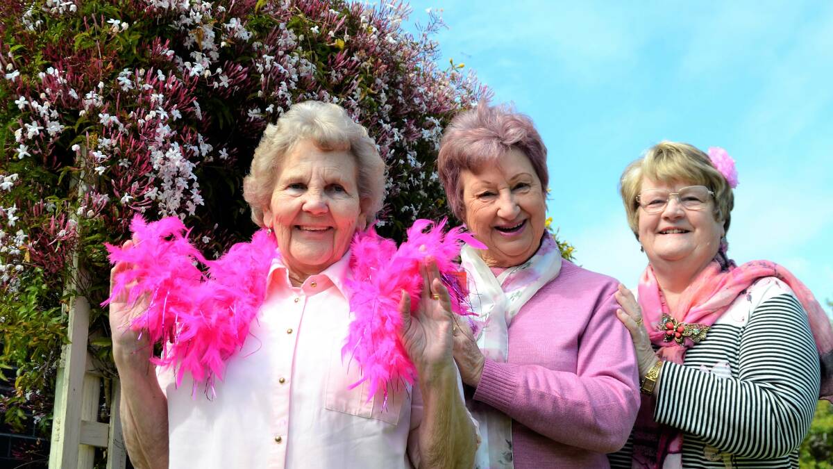 Turning pink: Golden Oldies members Doreen Harris, Heather Scott and Rae Taylor held a fundraising dinner for the cause. Photo: Emily Sharp.  