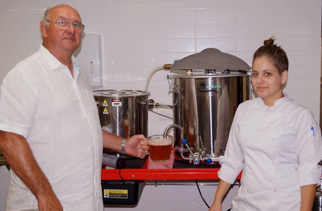 Master brewer Erich Massberg demonstrates the brewing process to student Cleo Stavrou.