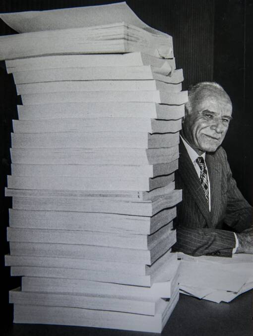 Justice Robert Hope "possessed a wide repertoire of skills to make his point". Shown here with the 6000 pages of transcripts taken during the royal commission into Australia's security and intelligence agencies.