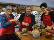 CLASS IN SESSION: ECU Bunbury Dean Lyn Farrell and School of Education Senior Lecturer David Rhodes don the apron and get cooking under the watchful eye of trainer Alex Taucher. Picture: Ivy James