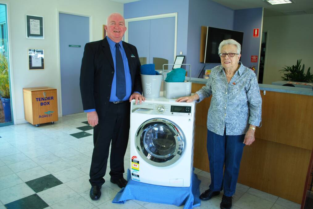 Aqwest Chief Executive Officer Brad Bevis presents the washing machine to Lorna Doe of Bunbury. 