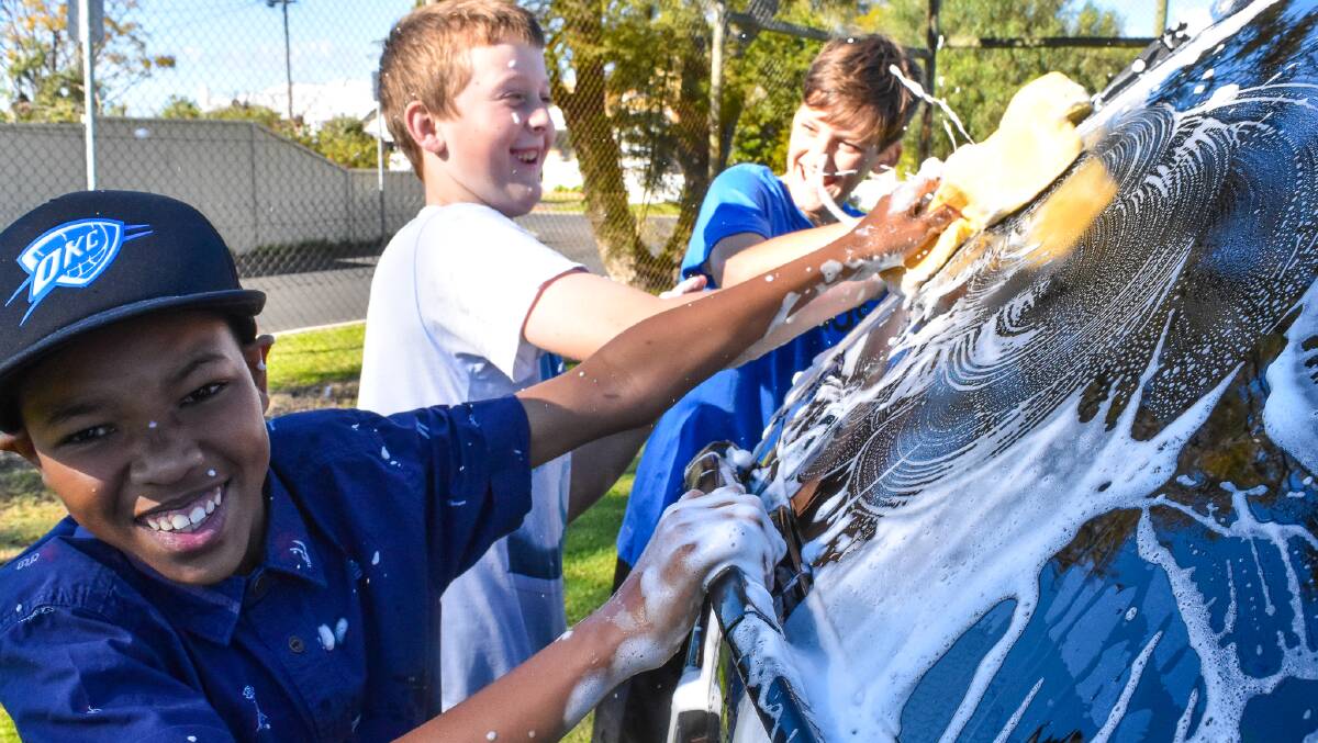 Lucky they bought a Jeep: the kids at Bunbury Primary School washed cars to raise money for camp. Photo: Jem Hedley