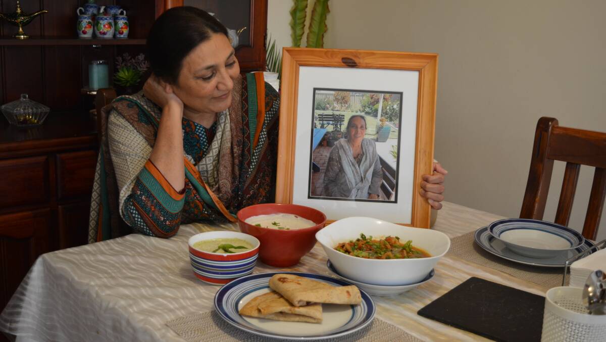 Shagufta Shakeel with the chicken karahi and a photo of her mother who taught her how to cook the dish.
