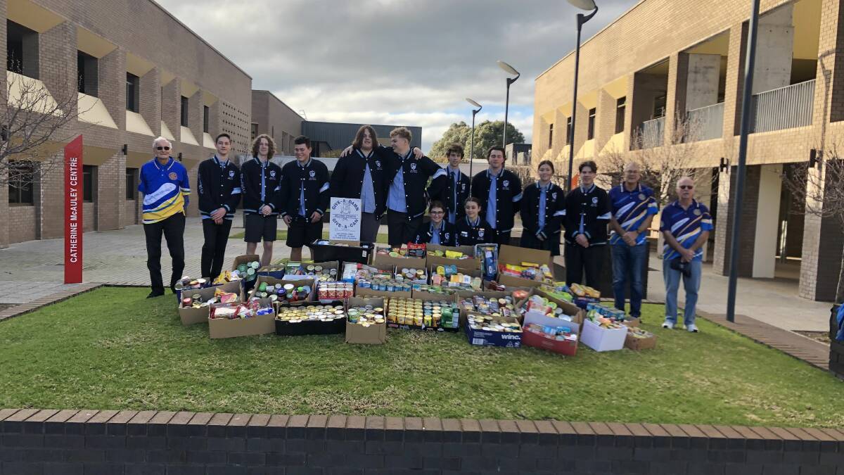 Give a Damn: Rotary Club of Bunbury Leschenault members Vic Puzey (left), Ian Pigott and John Bridgham (right) with Our Lady of Mercy College year 12 boys. Picture: supplied.