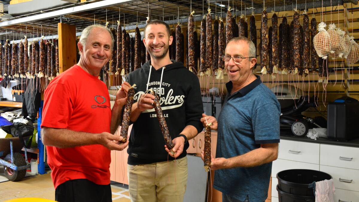Joe with his son Christopher and brother Paddy Carbone with their Italian snags drying out in the shed.