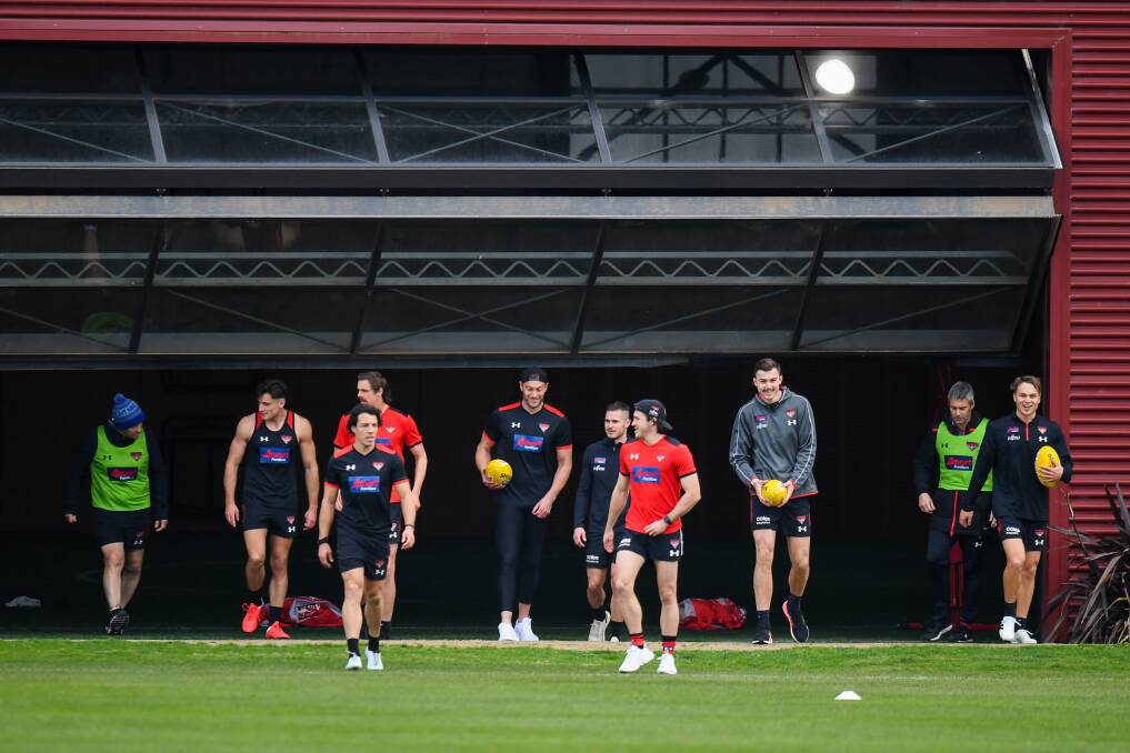 READY TO GO: Essendon players emerge from the hangar at training this week. Picture: Morgan Hancock