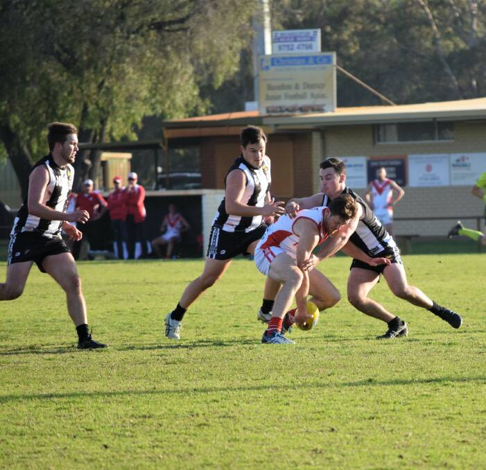 Magpie James Powley lays a tackle while Ethan Bowman and Aidan Fraser circle. Image Sophie Elliott.